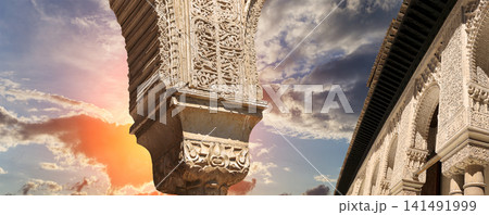 Arches in Islamic (Moorish) style (against the sunset) in Alhambra, Granada, Spain 141491999