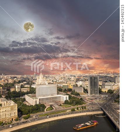 Aerial view of Moscow against the romantic evening sky with clouds and rays of the sun with the super moon. Government House of the Russian Federation (White House)-written in Russian, Russia 141492315