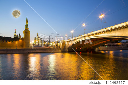 Night view of the Moskva River and Kremlin, Russia, Moscow (most popular view). Against the background of a beautiful sky with clouds, with the moon Night view of the Moskva River and Kremlin, Russia, Moscow (most popular view). Against the background of a beautiful sky with clouds, with the moon 141492327