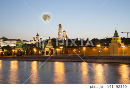Night view of the Moskva River and Kremlin, Russia, Moscow (most popular view). Against the background of a beautiful sky with clouds, with the moon Night view of the Moskva River and Kremlin, Russia, Moscow (most popular view). Against the background of a beautiful sky with clouds, with the moon 141492330