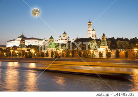 Night view of the Moskva River and Kremlin, Russia, Moscow (most popular view). Against the background of a beautiful sky with clouds, with the moon Night view of the Moskva River and Kremlin, Russia, Moscow (most popular view). Against the background of a beautiful sky with clouds, with the moon 141492333