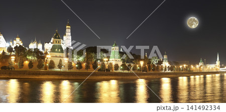 Night view of the Moskva River and Kremlin, Russia, Moscow (most popular view). Against the background of a beautiful sky with clouds, with the moon Night view of the Moskva River and Kremlin, Russia, Moscow (most popular view). Against the background of a beautiful sky with clouds, with the moon 141492334