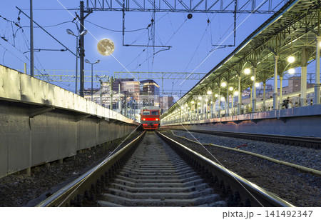 Train on Moscow passenger platform at night (Belorussky railway station), with the super moon -- is one of the nine main railway stations in Moscow, Russia. 141492347