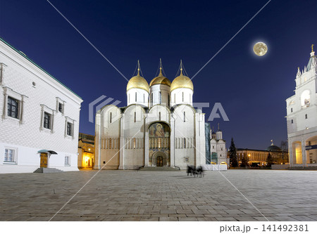 Assumption Cathedral (was the site of coronation of Russian tsars) at night, with the super moon. Cathedral Square, Inside of Moscow Kremlin, Russia. UNESCO World Heritage Site 141492381