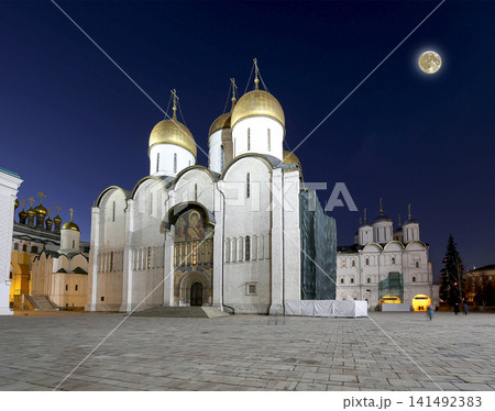 Assumption Cathedral (was the site of coronation of Russian tsars) at night, with the super moon. Cathedral Square, Inside of Moscow Kremlin, Russia. UNESCO World Heritage Site Assumption Cathedral (was the site of coronation of Russian tsars) at night, with the super moon. Cathedral Square, Inside of Moscow Kremlin, Russia. UNESCO World Heritage Site 141492383