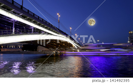 Bolshoy Ustinsky Bridge (with the super moon), Moscow, Russia-- is a steel arch bridge that spans Moskva River near the mouth of Yauza River, connecting the Boulevard Ring with Zamoskvorechye district 141492395