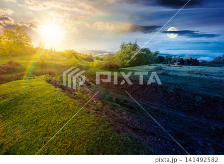 foggy carpathian mountain landscape. day meet night. outdoor adventure with stunning view in light at twilight. countryside landscape with rolling hills, fog and cloudy sky. harmony concept foggy carpathian mountain landscape. day meet night. outdoor adventure with stunning view in light at twilight. countryside landscape with rolling hills, fog and cloudy sky. harmony concept 141492582