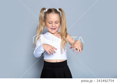 This young model stands with confidence, embodying strength and self-assurance in her trendy outfit. The photo captures the idea of how fashion can empower even the youngest individuals, perfect for a This young model stands with confidence, embodying strength and self-assurance in her trendy outfit. The photo captures the idea of how fashion can empower even the youngest individuals, perfect for a 141492754