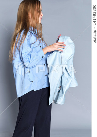 Child with gentle look, fashion echoing her soft demeanor. Great for brand narratives focused gentle 141492800