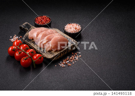 Fresh raw chicken fillet with salt and spices for home cooking. Raw chicken fillet 141493118
