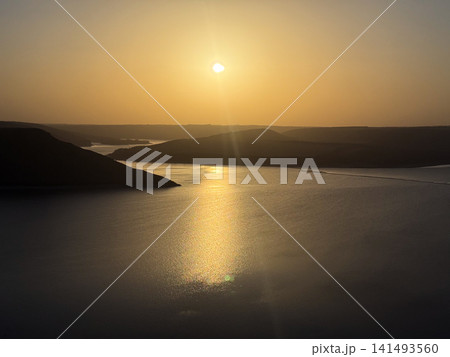 Sunset over a lake creating warm golden light Sunset over a lake creating warm golden light 141493560