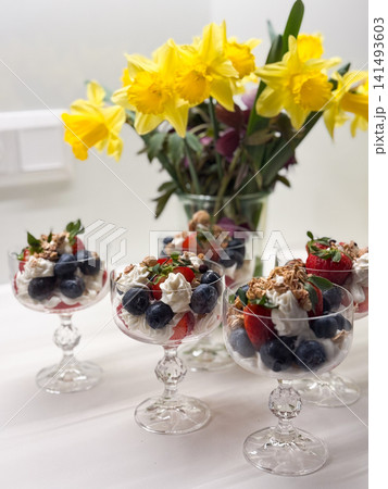 Berry parfait desserts with whipped cream and granola 141493603
