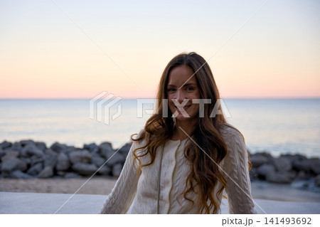 Portrait Of A Smiling Woman With Long Hair By The Ocean Portrait Of A Smiling Woman With Long Hair By The Ocean 141493692