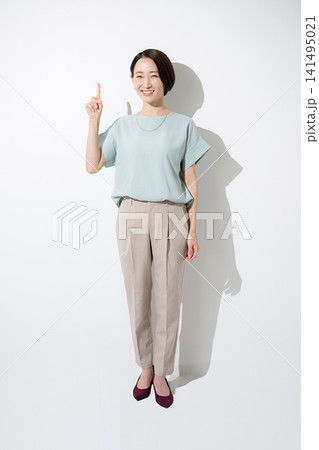 白背景で笑顔で指を差すポイントポーズの日本人女性 成功・達成・応援を表現する働く女性の全身イメージ 白背景で笑顔で指を差すポイントポーズの日本人女性 成功・達成・応援を表現する働く女性の全身イメージ 141495021