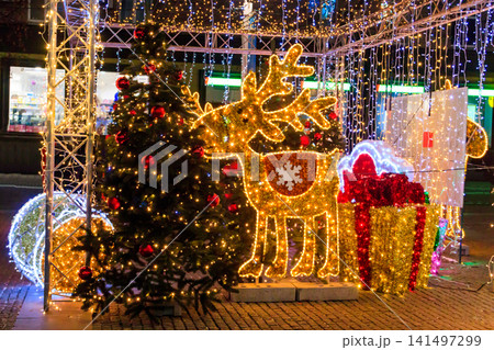 Illuminated Christmas deer at night. Decoration for Christmas and New Years holidays in a city park 141497299