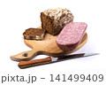 Dark bread and sausage on the kitchen table 141499409