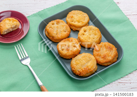 deep fried lotus root slices stuffed with savory meat filling deep fried lotus root slices stuffed with savory meat filling 141500183