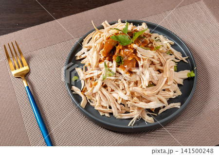 shredded chicken breast meat drizzled with savory peanut sauce 141500248