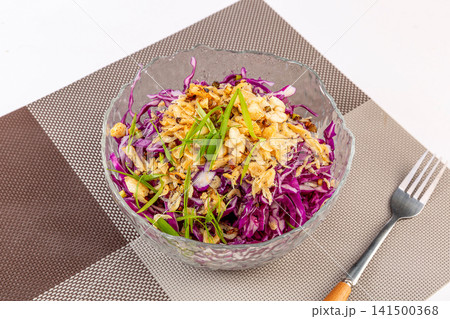 chilled shredded purple cabbage salad topped with crushed peanuts 141500368