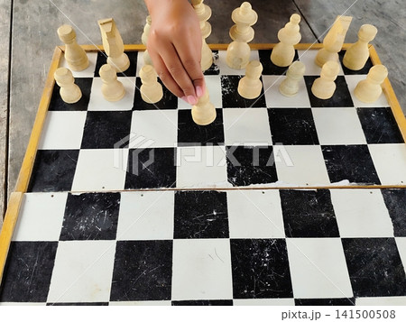 hand holding a chess piece hand holding a chess piece 141500508