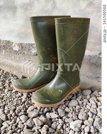 a pair of boots next to the wall a pair of boots next to the wall 141500568