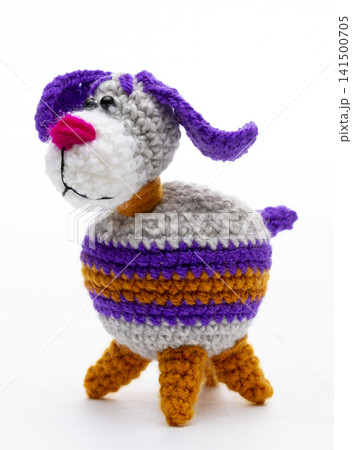Knitted woolen dog on a white background Knitted woolen dog on a white background 141500705