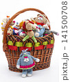 Various knitted wool toys in a bag on a white background. 141500708