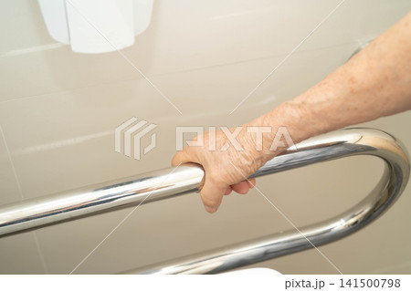 Asian elderly woman use safety handrail in bathroom. Asian elderly woman use safety handrail in bathroom. 141500798