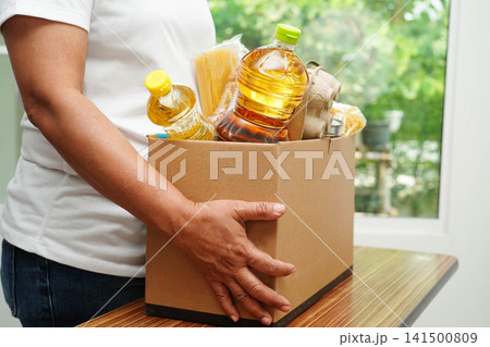 Foodstuffs in donation box for volunteer to help people. Foodstuffs in donation box for volunteer to help people. 141500809