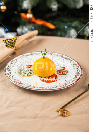 Healthy New Year mochi dessert shaped like orange in festive plate low calorie dairy lactose vegetarian natural ingredients holiday background Healthy New Year mochi dessert shaped like orange in festive plate low calorie dairy lactose vegetarian natural ingredients holiday background 141501382