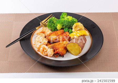 low Calorie Fitness Meal With Boiled Shrimps Hard Boiled Eggs Purple Sweet Potatoes And Greens 141501599
