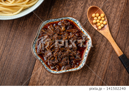 chinese Toona Sinensis sauce in a ceramic dish, traditional Asian herb condiment, savory paste for cooking and dipping, top view. chinese Toona Sinensis sauce in a ceramic dish, traditional Asian herb condiment, savory paste for cooking and dipping, top view. 141502240