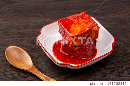 traditional Tianjin style fermented bean curd cubes coated in rich spicy red chili oil, savory preserved sufu delicacy. traditional Tianjin style fermented bean curd cubes coated in rich spicy red chili oil, savory preserved sufu delicacy. 141502315