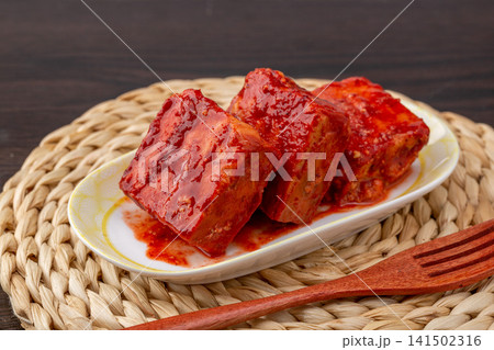 traditional Tianjin style fermented bean curd cubes coated in rich spicy red chili oil, savory preserved sufu delicacy. traditional Tianjin style fermented bean curd cubes coated in rich spicy red chili oil, savory preserved sufu delicacy. 141502316