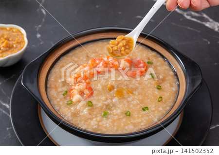 savory Chinese rice congee with fresh shrimp and scallop soybean paste topping, authentic comforting Asian seafood porridge. savory Chinese rice congee with fresh shrimp and scallop soybean paste topping, authentic comforting Asian seafood porridge. 141502352