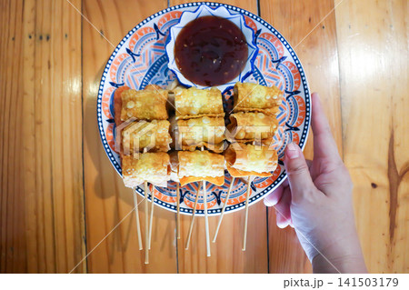 fried wonton, deep fried wonton or fried dumpling or deep fried dumpling and dip 141503179