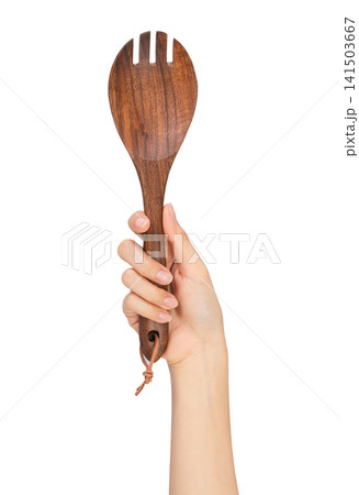 Clipping path, Hand holding wooden cooking spoon isolated on white background. 141503667