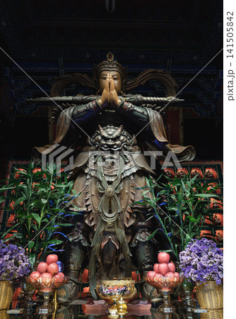 An intricate temple sculpture of Wei Tuo (Skanda Bodhisattva), a powerful Chinese Buddhist Dharma protector. Captured inside the historic Luohan Temple in downtown Chongqing, the robust warrior deity An intricate temple sculpture of Wei Tuo (Skanda Bodhisattva), a powerful Chinese Buddhist Dharma protector. Captured inside the historic Luohan Temple in downtown Chongqing, the robust warrior deity 141505842