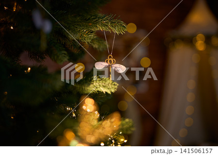 Winged Key Christmas Ornament on an Evergreen Tree 141506157