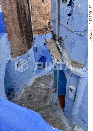 Winding cobblestone steps descending through painted blue buildings, Chefchaouen Medina, Morocco Winding cobblestone steps descending through painted blue buildings, Chefchaouen Medina, Morocco 141506180