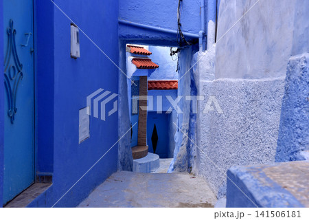 Traditional painted houses along narrow blue street in Chefchaouen Medina, Morocco Traditional painted houses along narrow blue street in Chefchaouen Medina, Morocco 141506181