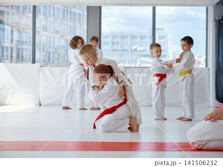 Youth martial arts, children focused on judo drills with partners 141506232