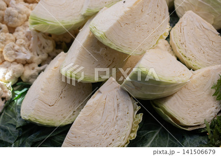 Fresh organic heads of cabbages cut in pieces on the farmers market. Fresh organic heads of cabbages cut in pieces on the farmers market. 141506679