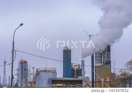 Urban industrial scene. Cityscape with smoke and silos. Industrial horizon with smoke and distant pipelines Urban industrial scene. Cityscape with smoke and silos. Industrial horizon with smoke and distant pipelines 141507632
