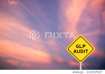 Yellow transportation sign with word GLP (Abbreviation of Good laboratory practice) audit on violet color sky background 141507927