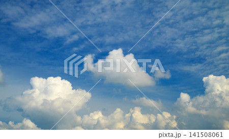white cumulus clouds in a bright blue sky on a clear summer day white cumulus clouds in a bright blue sky on a clear summer day 141508061