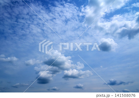 light grayish clouds scattered across blue summer sky 141508076