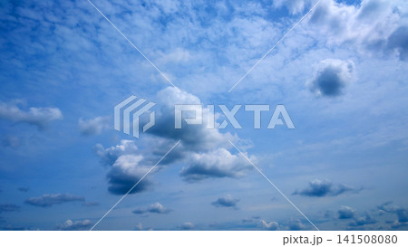 sparse white and grayish clouds floating in blue summer sky sparse white and grayish clouds floating in blue summer sky 141508080