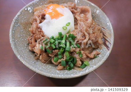 Rice topped with stir fried pork or stir fried beef and egg or Japanese food or Korean food or Beef Rice Bowl , Gyudon Rice topped with stir fried pork or stir fried beef and egg or Japanese food or Korean food or Beef Rice Bowl , Gyudon 141509329