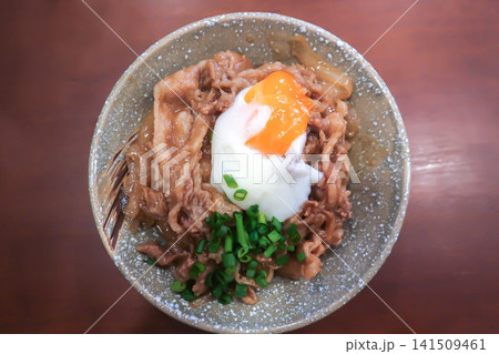 Rice topped with stir fried pork or stir fried beef and egg or Japanese food or Korean food or Beef Rice Bowl , Gyudon Rice topped with stir fried pork or stir fried beef and egg or Japanese food or Korean food or Beef Rice Bowl , Gyudon 141509461